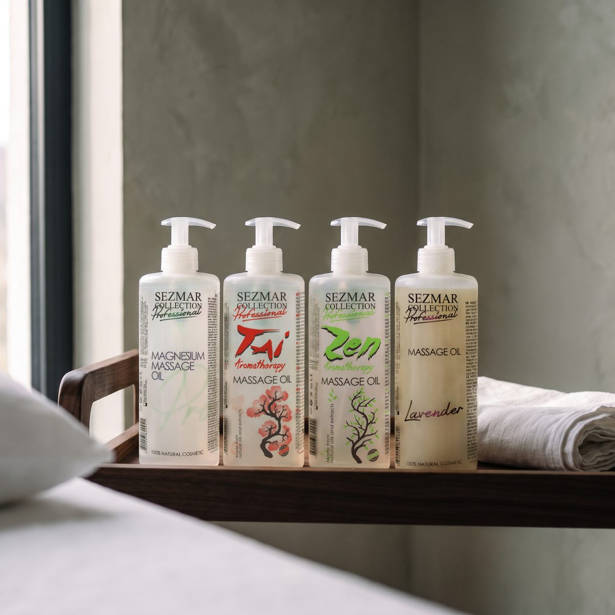 Magnesium, Tai, Zen and Lavender massage oils 500 ml in a row on a wooden trolley